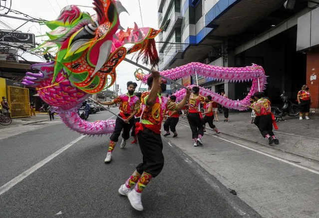 Dragon dancers perform at a residential and commercial district in Quezon City, Metro Manila, Philippines, 01 February 2022. Metro Manila welcomed the Year of the Tiger in the Chinese lunar calendar on 01 February with less traditional fanfare and crowded festivities in public spaces even as authorities gradually eased COVID-19 lockdown protocols and allowed citizens more movement outside their homes. (Photo by Rolex Dela Pena/EPA/EFE/Rex Features/Shutterstock)