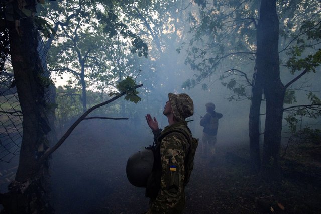 Smoke lingers in the air after a howitzer fired at a Russian position on May 27, 2024. (Photo by Thomas Peter/Reuters)