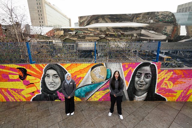 Boxing coach Haseebah Abdullah and cricketer Salma Bi stand by a commemorative mural depicting themselves and designed by one of the UK's most prolific street artists, Gent 48 on Tuesday, January 11, 2022. The mural is unveiled in central Birmingham during the official launch to find 2,022 Batonbearers to take part in the Queen's Baton Relay across England for the Birmingham 2022 Commonwealth Games. (Photo by Jacob King/PA Images via Getty Images)