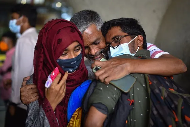 An Indian student is embraced by his family members at Chennai Airport after returning from Ukraine following the Russian invasion of Ukraine, in Chennai, India, 27 February 2022. Indian students returned from Ukraine after the Indian embassy in Kyiv urged them to leave the country temporarily amid Russian troops fighting in Ukraine. Russian troops entered Ukraine on 24 February prompting the country's president to declare martial law and triggering a series of announcements by Western countries to impose severe economic sanctions on Russia. (Photo by Idrees Mohammed/EPA/EFE)