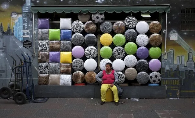 A woman sits in front of a shop selling stools after buying one in the Bras neighborhood of Sao Paulo in this August 9, 2013 file photo. Brazil is expectyed to release May retail sales data this week. (Photo by Nacho Doce/Reuters)