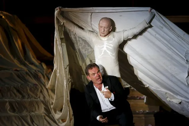 Actors Cornelius Obonya as Jedermann (front) and Peter Lohmeyer as Tod perform on stage during a dress rehearsal of Hugo von Hofmannsthal's drama “Jedermann” (Everyman) at Domplatz square in Salzburg, Austria, July 16, 2015. (Photo by Leonhard Foeger/Reuters)