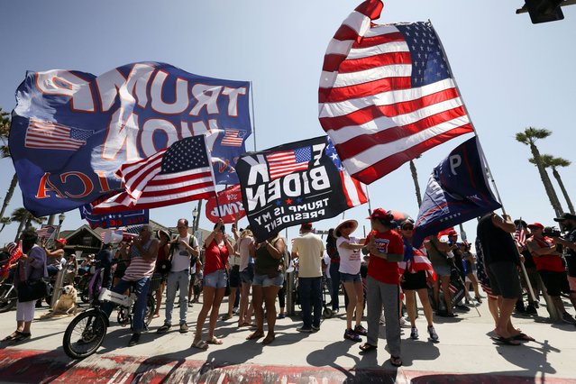 Pro-Trump supporters gather during a demonstration in support of former Donald Trump, who was shot the previous day in an assassination attempt, during a rally in Pennsylvania, in Huntington Beach, California on July 14, 2024. (Photo by Etienne Laurent/Reuters)