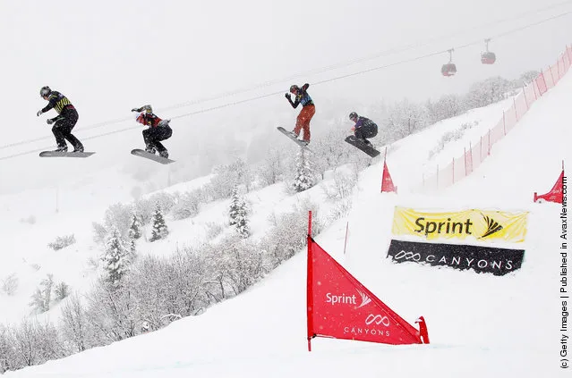 Nate Holland (L) leads Jarryd Hughes (2L) in their semifinal heat of the men's Sprint U.S. Grand Prix Snowboardcross Finals at The Canyons Ski Resort