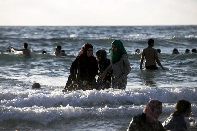 Muslim women enjoy the water of the Mediterranean sea in Tel Aviv during Eid al-Fitr, which marks the end of the holy month of Ramadan, July 19, 2015. (Photo by Baz Ratner/Reuters)