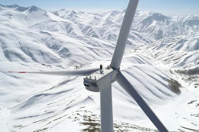 An aerial view of a wind power plant in Van, Turkiye on February 24, 2022. The wind power plant was established at an altitude of 3 thousand in the Gevas district of Van. Wind power plants produce energy for 50 thousand houses. Van, with its deep valleys between the high mountains, is among the most productive cities where wind energy can be produced. A wind power plant with 14 wind turbines was established to bring this potential to the economy. (Photo by Ozkan Bilgin/Anadolu Agency via Getty Images)