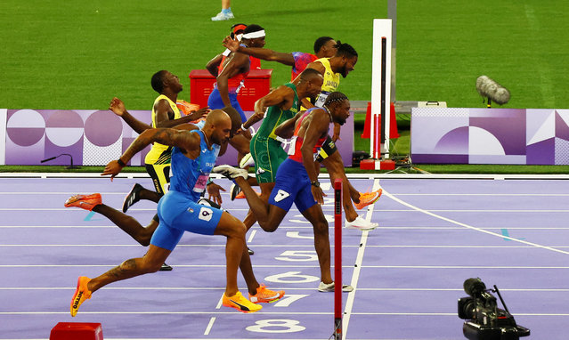 Noah Lyles of the United States crosses the line to win gold in the men's 100m final on August 4, 2024. (Photo by Agustin Marcarian/Reuters)