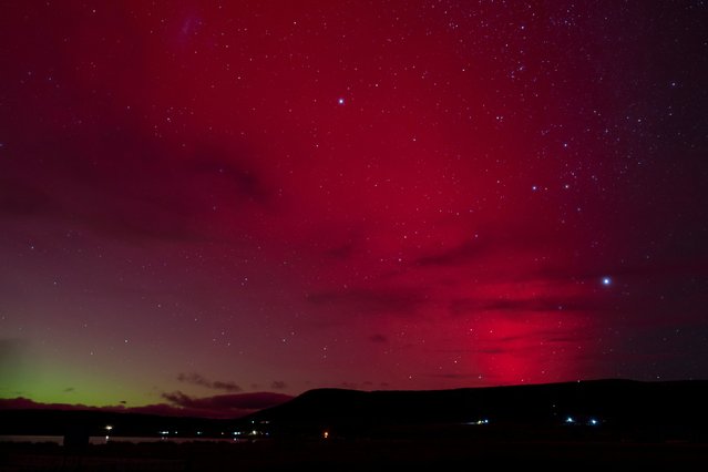 A view shows the lights of an aurora australis caused by a geomagnetic storm, in Punta Carrera, Chile on May 10, 2024. (Photo by Joel Estay/Reuters)