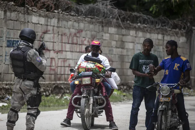 A police officer patrols a street during an anti-gang operation in Croix-des-Missions north of Port-au-Prince, Haiti, Thursday, April 28, 2022. (Photo by Joseph Odelyn/AP Photo)