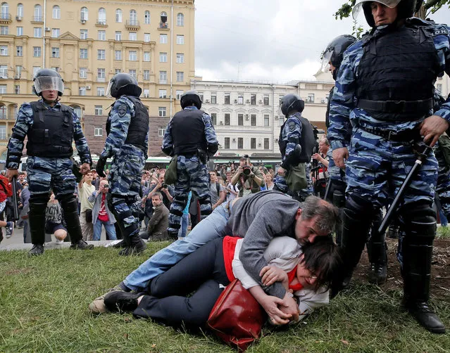 Activist Yulia Galyamina and her husband Nikolai Tuzhilin lie on the ground next to riot police during an anti-corruption protest organised by opposition leader Alexei Navalny, on Tverskaya Street in central Moscow, Russia June 12, 2017. (Photo by Maxim Shemetov/Reuters)