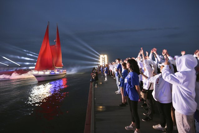 A yacht with scarlet sails floats during the Scarlet Sails festivities marking school graduation, in Mariupol, Russian-controlled Donetsk region, eastern Ukraine, Sunday, June 18, 2023. (Photo by Alexei Alexandrov/AP Photo)