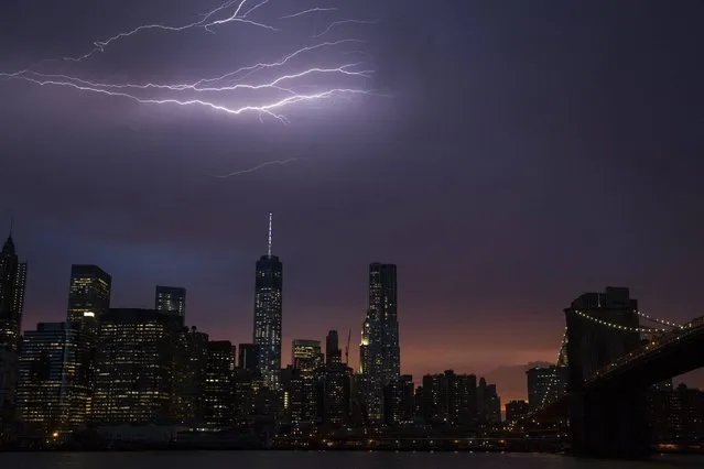 Lightning strikes above the Manhattan skyline during sunset after a summer storm in New York on July 2, 2014. (Photo by Lucas Jackson/Reuters)