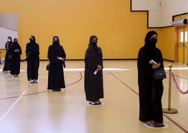 Voters line up at a polling station in the Gulf Arab state's first legislative elections for two-thirds of the advisory Shura Council, in Doha, Qatar on October 2, 2021. (Photo by Ibraheem Al Omari/Reuters)