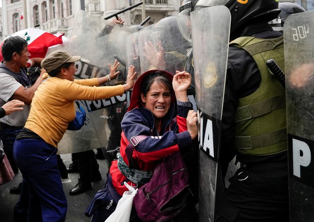 Anti-government demonstrators clash with police officers during a national protest to demand the resignation of Peruvian President Dina Boluarte, in Lima, Peru on July 29, 2023. (Photo by Angela Ponce/Reuters)