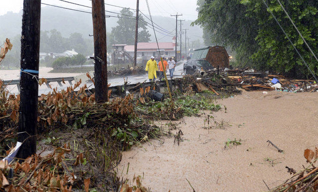 In this photo made from video, debris from the Jordan Creek near Clendenin, W.Va., piles up against a culvert along U.S. 119 on Thursday night June 23, 2016, just before the creek's entry into the Elk River. Multiple fatalities have been reported in flooding that has devastated parts of the state, a state official said Friday morning. (Photo by Chris Dorst/Gazette-Mail via AP Photo)