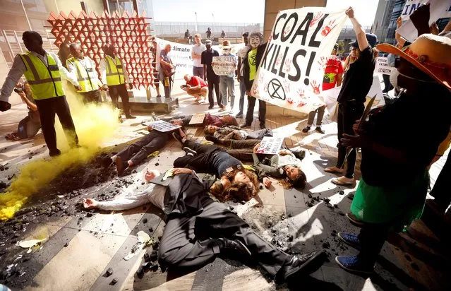 Environmental activists stage a mock “die in” as they protest outside the venue hosting the Southern African Coal Conference in Cape Town, South Africa on January 30, 2020. (Photo by Mike Hutchings/Reuters)