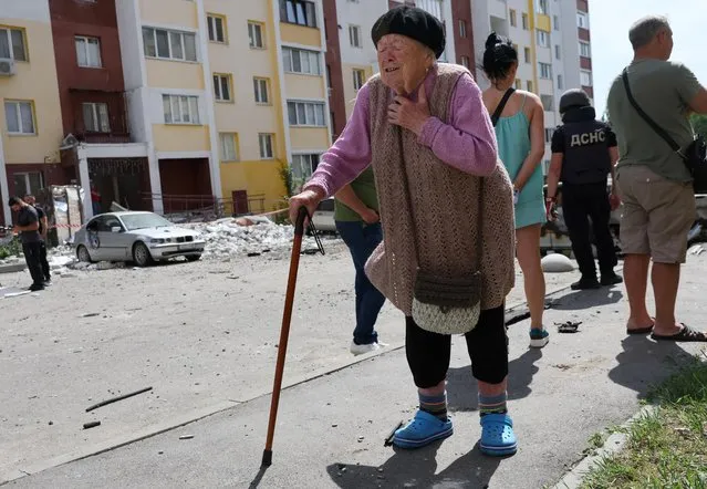 Irina Homenko, 91, emotes about the aftermath of overnight shelling in her apartment complex as Russia’s attack on Ukraine continues in Kharkiv, Ukraine, June 26, 2022. (Photo by Leah Millis/Reuters)