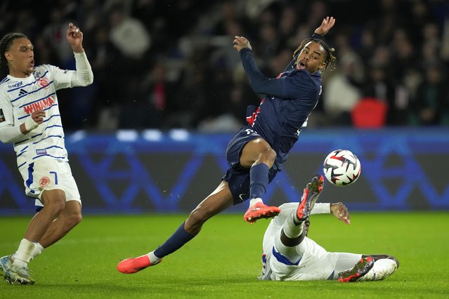 PSG's Bradley Barcola, center, gets in a shot during the French League One soccer match between Paris Saint-Germain and Strasbourg at the Parc des Princes in Paris, Saturday, October 19, 2024. (Photo by Christophe Ena/AP Photo)