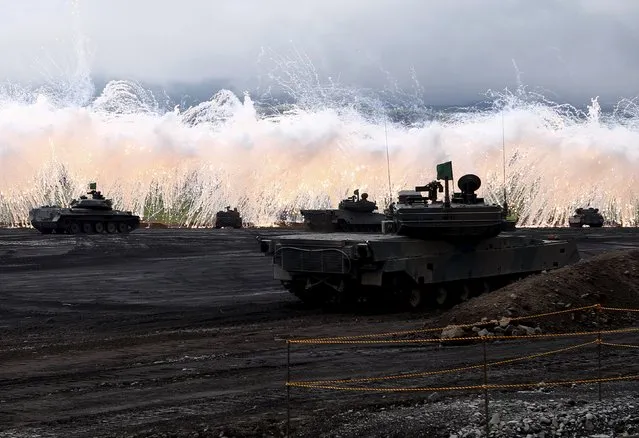 Japanese Ground Self-Defense Force tanks and other armoured vehicles take part in an annual training session, which is based on a scenario to defend or retake islands in Japanese territory, near Mount Fuji at Higashifuji training field in Gotemba, west of Tokyo, August 18, 2015. (Photo by Yuya Shino/Reuters)