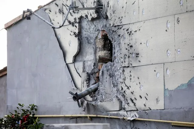 A part of a rocket hangs from a damaged wall of a building not far from the city of Mykolaiv, Ukraine, 12 July 2022. Russian troops on 24 February entered Ukrainian territory, starting a conflict that has provoked destruction and a humanitarian crisis. (Photo by Mikhail Palinchak/EPA/EFE/Rex Features/Shutterstock)