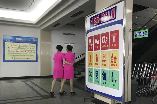 In this Monday, June 19, 2017, photo, staff members walk toward the escalators of the Potonggang department store in Pyongyang, North Korea. (Photo by Wong Maye-E/AP Photo)
