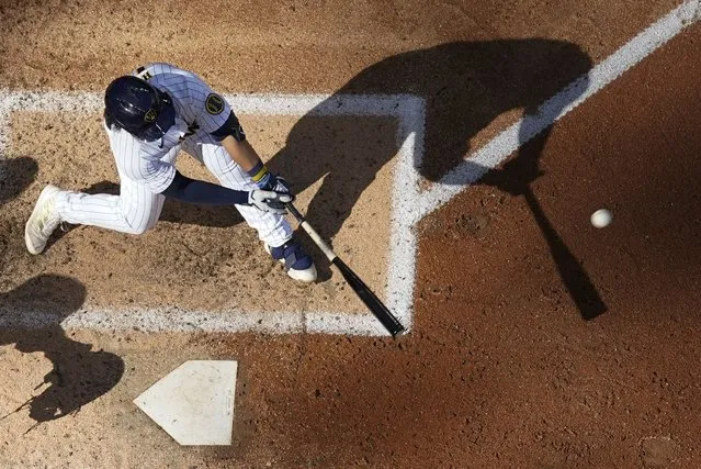Milwaukee Brewers' Keston Hiura hits an RBI single during the sixth inning of a baseball game against the Pittsburgh Pirates Saturday, July 9, 2022, in Milwaukee. (Photo by Morry Gash/AP Photo)
