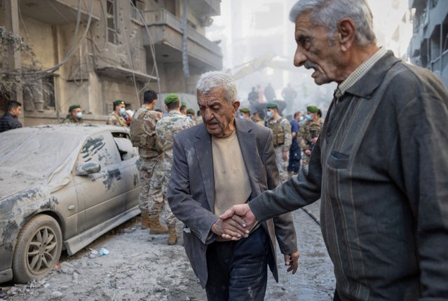 A man covered in dust leaves after being rescued at the site of an Israeli strike in Beirut's Basta neighbourhood, amid the ongoing hostilities between Hezbollah and Israeli forces, Lebanon on November 23, 2024. (Photo by Adnan Abidi/Reuters)