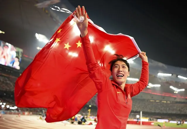 Second placed Lyu Huihui of China celebrates with a national flag after winning silver in the women's javelin throw final during the 15th IAAF World Championships at the National Stadium in Beijing, China, August 30, 2015. (Photo by Dylan Martinez/Reuters)