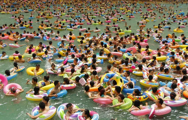 Holidaymakers crowd China’s largest and busiest swimming pool, also known as China’s Dead Sea in Daying county, China on July 18, 2016, on a scorching day. (Photo by Imaginechina/Rex Shutterstock)