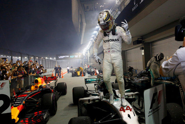 Mercedes' British driver Lewis Hamilton celebrates winning the Formula One Singapore Grand Prix in Singapore on September 17, 2017. (Photo by Edgar Su/Reuters)