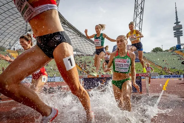 Athlets cross the water jump in the womens 3000 meter steeplechase race at the Olympiastadion in Munich, Germany during the 2022 European Championships on August 18, 2022. (Photo by Morgan Treacy/INPHO)