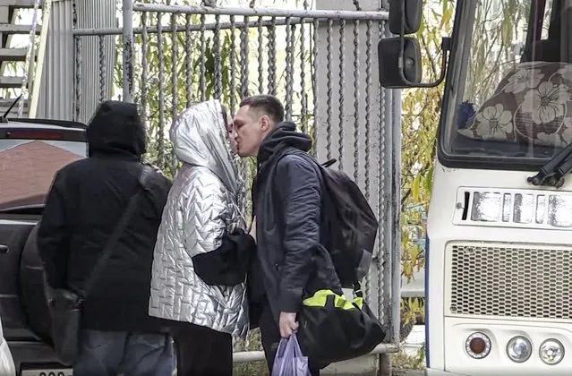 In this image taken from video, a Russian draftee kisses his partner before boarding a bus to be sent to the military units of the Eastern Military District, in Yakutsk, Russia, Friday, September 23, 2022. Mobilization is underway in Russia's Far Eastern region of Yakutia after President Vladimir Putin ordered a partial mobilization of reservists Wednesday to bolster his forces in Ukraine. (Photo by AP Photo/Stringer)
