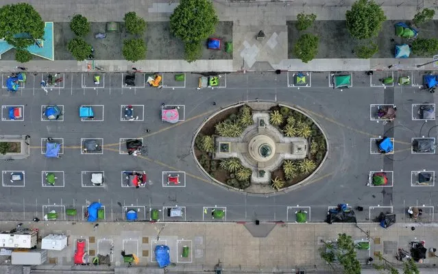 An aerial view of San Francisco's first temporary sanctioned tent encampment for the homeless on May 18, 2020 in San Francisco, California. After public outrage mounted over a surge of homeless people and tents filling the streets of San Francisco during the coronavirus (COVID-19) pandemic, the City opened its first temporary sanctioned tent encampment this week. The camp provides a safe sleeping area in a fenced-off space near City Hall with marked spots for tents that practice social distancing. Toilets, hand washing stations and 24 hours security will also be provided. Other locations throughout the city will be opening soon. (Photo by Justin Sullivan/Getty Images)