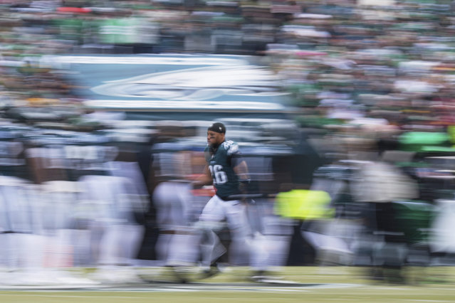 In this image taken with a slow shutter speed, Philadelphia Eagles running back Saquon Barkley is introduced before the NFC Championship NFL football game against the Washington Commanders, Sunday, January 26, 2025, in Philadelphia. (Photo by Matt Slocum/AP Photo)