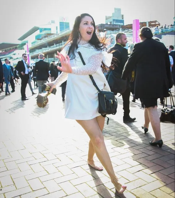 A barefoot woman strolls along, shoes in hand, on 2017 Derby Day at Flemington Racecourse on November 4, 2017 in Melbourne, Australia. (Photo by Splash News and Pictures)