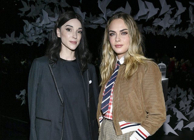 American singer St. Vincent, left, and English model and actress Cara Delevingne attend the Thom Browne Fall/Winter 2025 fashion show as part of New York Fashion Week on Tuesday, February 11, 2025, at The Shed in New York. (Photo by Evan Agostini/Invision/AP Photo)