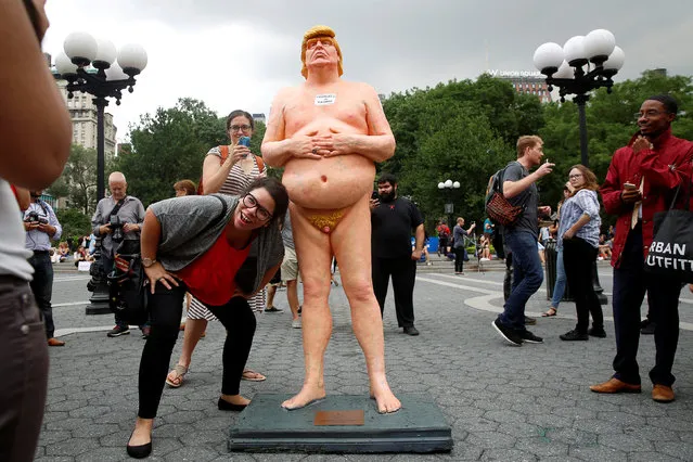 People photograph a naked statue of U.S. Republican presidential nominee Donald Trump that was left in Union Square Park in New York City, U.S. August 18, 2016. (Photo by Brendan McDermid/Reuters)