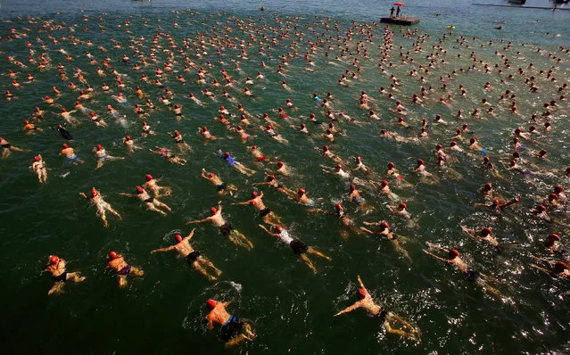 People swim during the annual public Lake Zurich crossing swimming event over a distance of 1,500 metres (4,921 ft) in Zurich, Switzerland, August 24, 2016. (Photo by Arnd Wiegmann/Reuters)