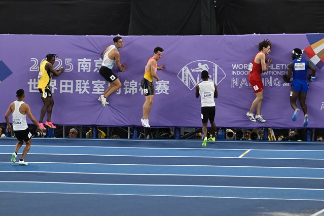 Athletes hit a soft board after crossing the finishing line in the men's 60m heats during the Indoor World Athletics Championships in Nanjing, in eastern China's Jiangsu province on March 21, 2025. (Photo by Wang Zhao/AFP Photo)