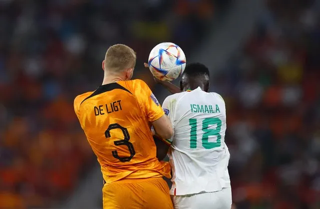 Ismaila Sarr (R) fights for the ball with Netherlands' defender #03 Matthijs De Ligt during the Qatar 2022 World Cup Group A football match between Senegal and the Netherlands at the Al-Thumama Stadium in Doha on November 21, 2022. (Photo by Kai Pfaffenbach/Reuters)