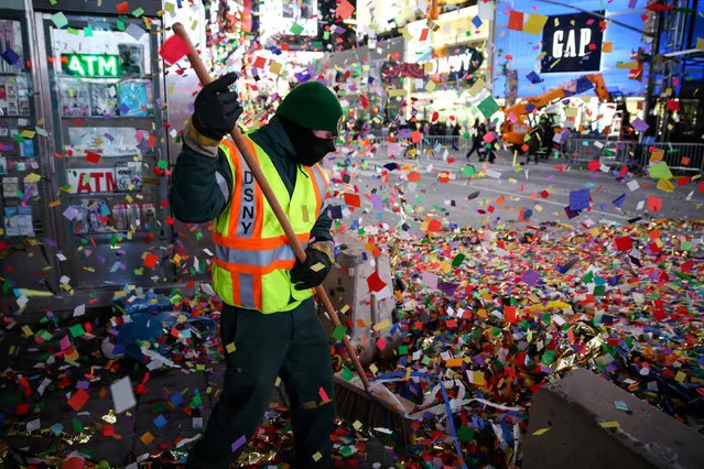 A city sanitation worker cleans the streets after the new year celebrations in Times Square in New York, USA on January 1, 2018. (Photo by Amr Alfiky/Reuters)