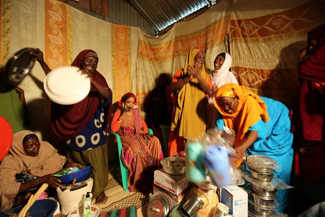The families of newly married Somali couple Mohamed Noor and Huda Omar gather to give them gifts for their new home in Mogadishu's Rajo camp, Somalia August 24, 2016. (Photo by Feisal Omar/Reuters)