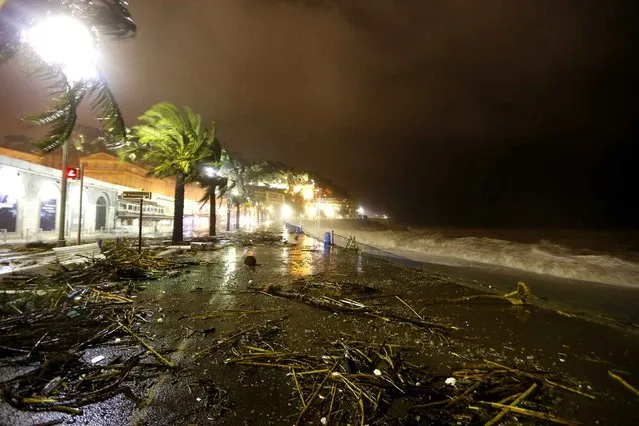 This picture taken on November 4, 2014 in the French Riviera city of Nice, southeastern France shows the “promenade des Anglais” strewn with debris. Large waves broke against barriers at the harbour of Nice, as the French national meteorological service expanded to 16 the number of French departments on orange alert (the second highest weather warning), due to storms, heavy rain and a risk of flooding in some areas. (Photo by Valery Hache/AFP Photo)