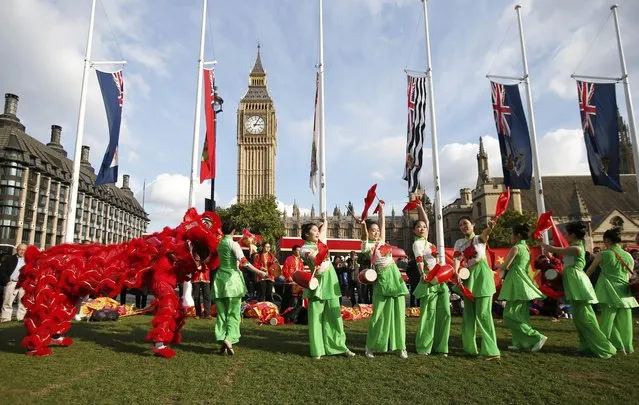 Supporters of China's President Xi Jinping perform opposite Big Ben in Parliament Square ahead of Xi's address to both Houses of Parliament, in London, Britain, October 20, 2015. (Photo by Peter Nicholls/Reuters)