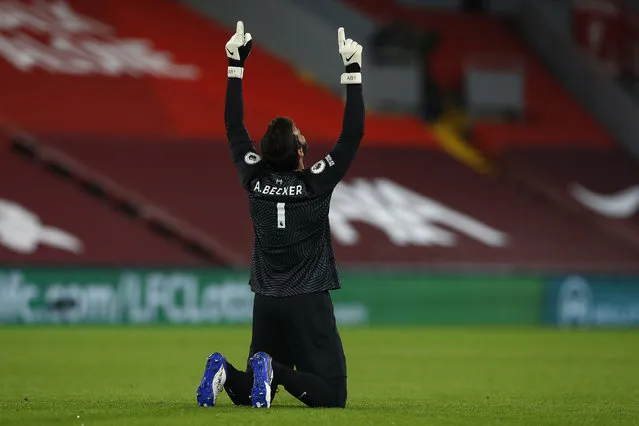 Liverpool's Brazilian goalkeeper Alisson Becker reacts after Liverpool's Portuguese striker Diogo Jota (unseen) scored his team's third goal during the English Premier League football match between Liverpool and Arsenal at Anfield in Liverpool, north west England on September 28, 2020. (Photo by Jason Cairnduff/Pool via AFP Photo)
