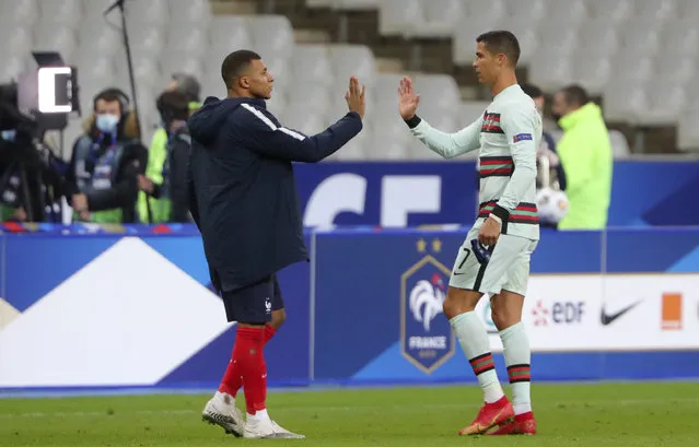 France's Kylian Mbappe and Portugal's Cristiano Ronaldo, right, greet each other at the end of the UEFA Nations League soccer match between France and Portugal at the Stade de France in Saint-Denis, north of Paris, France, Sunday, October 11, 2020. (Photo by Thibault Camus/AP Photo)