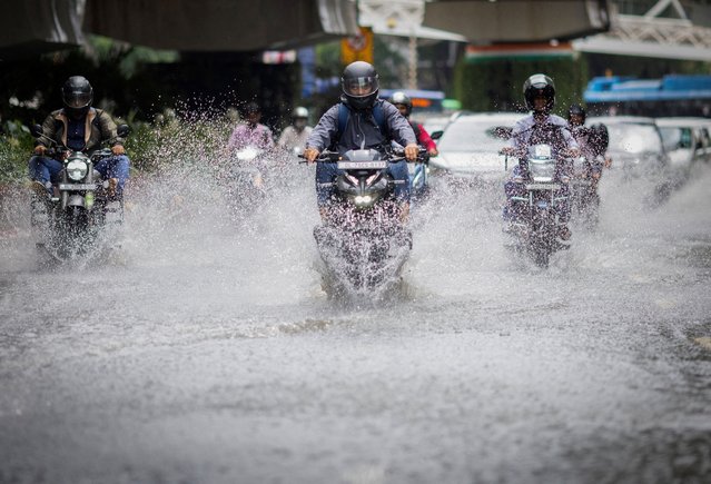 Vehicles move through a waterlogged street after heavy rains in New Delhi, India on July 29, 2025. (Photo by Adnan Abidi/Reuters)