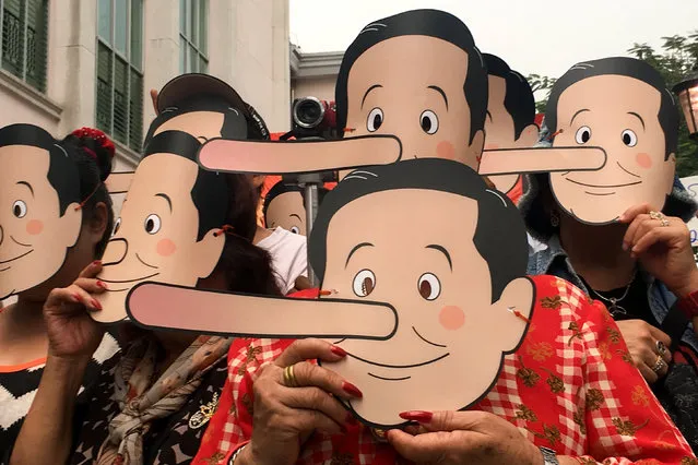 Pro-democracy activists wear masks mocking Thailand's Prime Minister Prayuth Chan-o-cha as Pinocchio during a protest against junta at a university in Bangkok, Thailand, February 24, 2018. (Photo by Panarat Thepgumpanat/Reuters/File Photo)