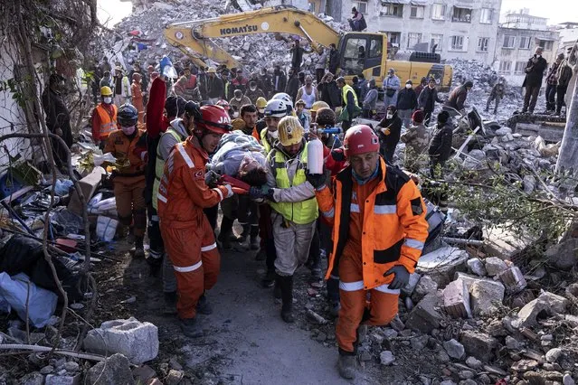 Rescue workers and medics pull out a person from a collapsed building in Antakya, Turkey, Wednesday, February 15, 2023. (Photo by Ugur Yildirim/DIA via AP Photo)