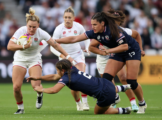 Megan Jones of England is tackled by Kathryn Treder and Ilona Maher of USA during the Women's Rugby World Cup 2025 Pool A match between England and USA at Stadium of Light on August 22, 2025 in Sunderland, England. (Photo by Paul Harding/Getty Images)